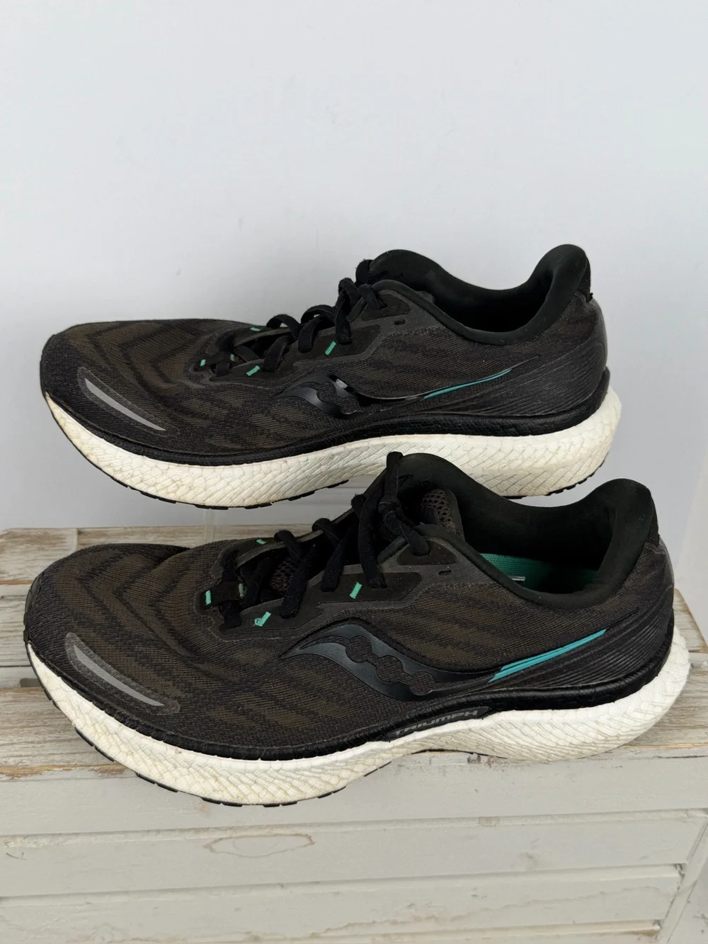 Saucony Triumph 19 running shoes in black an white with subtle teal accents 10.5